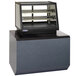 A black and silver Federal Industries countertop display case with a glass door on a counter.