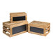 A group of natural wood crates with chalkboard panels on top.