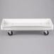 A white fiberglass MFG Tray dough proofing box dolly.