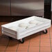 A white MFG Tray fiberglass dough proofing box dolly with dough inside.