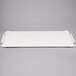 A white rectangular MFG Tray lid with handles.