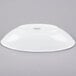 A Libbey Infinity white porcelain bowl on a gray surface.