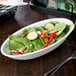 A salad in a white Libbey Infinity porcelain bowl on a table.