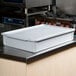 A white fiberglass MFG Tray dough proofing box lid on a white container.