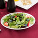 A Libbey oval porcelain platter with a salad of strawberries and blueberries.