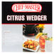 A Chef Master citrus wedge cutter with lemon wedges on a plate of shrimp.