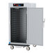 A white metal Metro C5 heated holding cabinet with shelves.