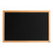 A black felt message board with a wood frame.