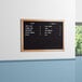A black Aarco felt message board with white text on it.