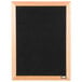 A black felt Aarco open face message board with a wooden frame.