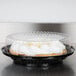 A D&W Fine Pack black pie in a plastic container with a clear dome lid.