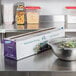 A bowl of salad wrapped in Choice Safecut foodservice film on a counter.