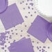 A table set with a purple polka dot paper plate and a Luscious Lavender purple napkin.