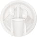 A white plastic plate with a white Creative Converting guest towel, spoon, fork, and knife.