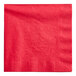 A close-up of a red napkin with a white background.