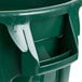 A green Rubbermaid BRUTE trash can with lid and dolly handles.
