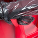 A red Rubbermaid BRUTE commercial trash can with a black plastic lid.