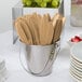 A bucket of Creative Converting Glittering Gold plastic knives on a white surface.