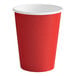 A red Creative Converting paper cup with a white lid.