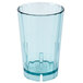 a blue glass with a white lid