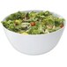 A white GET Diamond melamine bowl filled with salad with lettuce, tomatoes, and other vegetables.