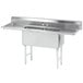 A stainless steel Advance Tabco two compartment sink with two drainboards.