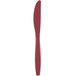 A close up of a burgundy plastic knife with a handle.