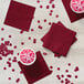 A table with red Creative Converting beverage napkins and drinks.