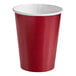 A red paper cup with a white wall.