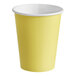 A yellow paper cup with a white rim.