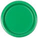 A close-up of a Creative Converting emerald green paper plate with a white circle in the center.