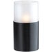 A close-up of a black Sterno Monacco lamp with a white candle burning.