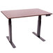 A Luxor standing desk with a black base and dark walnut top.