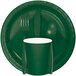 A close up of a Creative Converting hunter green paper plate with a fork and spoon on it.