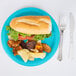 A Creative Converting Bermuda blue paper plate with a sandwich and potato chips.