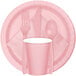 A close up of a pink Creative Converting paper plate with a fork, spoon, and knife.