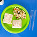 A Fresh Lime Green paper plate of food and a fork.