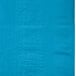 A turquoise blue paper table cover with embossed square designs.