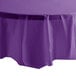 An amethyst purple plastic table cover on a white table.