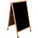 A black porcelain A-Frame board with a wooden frame.