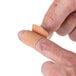 A person putting a Medique woven bandage strip on their finger.