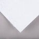 A white paper with a gray edge on top of a gray surface.