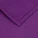 A close up of a purple fabric with a red stitch.