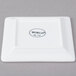 A white square Libbey porcelain plate with a black square rim.
