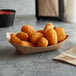 A natural eco-kraft paper food tray filled with tater tots.