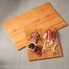 An American Metalcraft square bamboo melamine serving board with meat and olives on it.