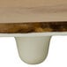 An oval melamine serving board with a faux rustic wood brown and white surface.