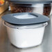 A Rubbermaid clear plastic container with a lid on a counter.