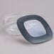 A clear square plastic container with a black lid.