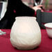 A Sterno frost Venetian candle on a table with food.